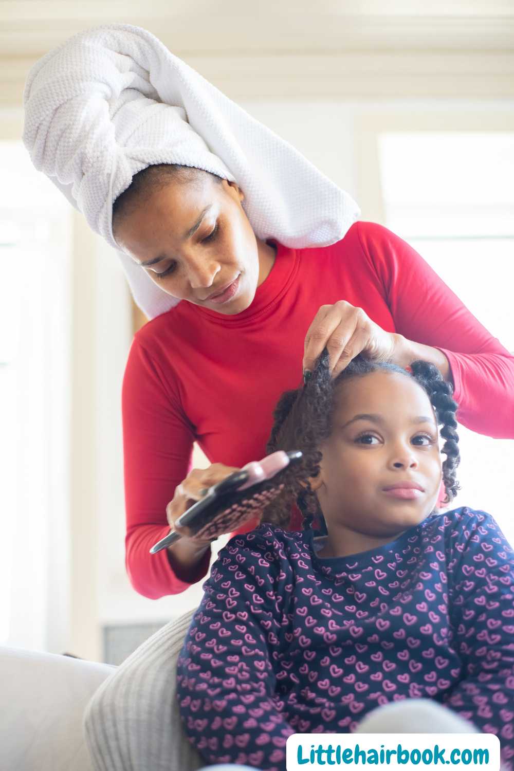 A child making her daughter's hair