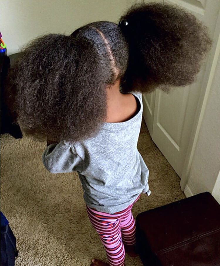a girl standing with full hair