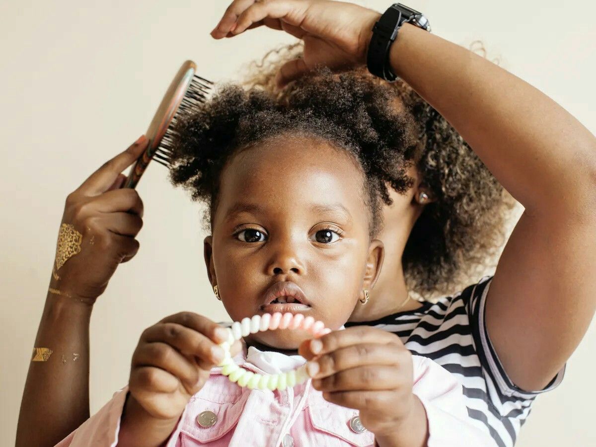 mum brushing her daughter's hair
