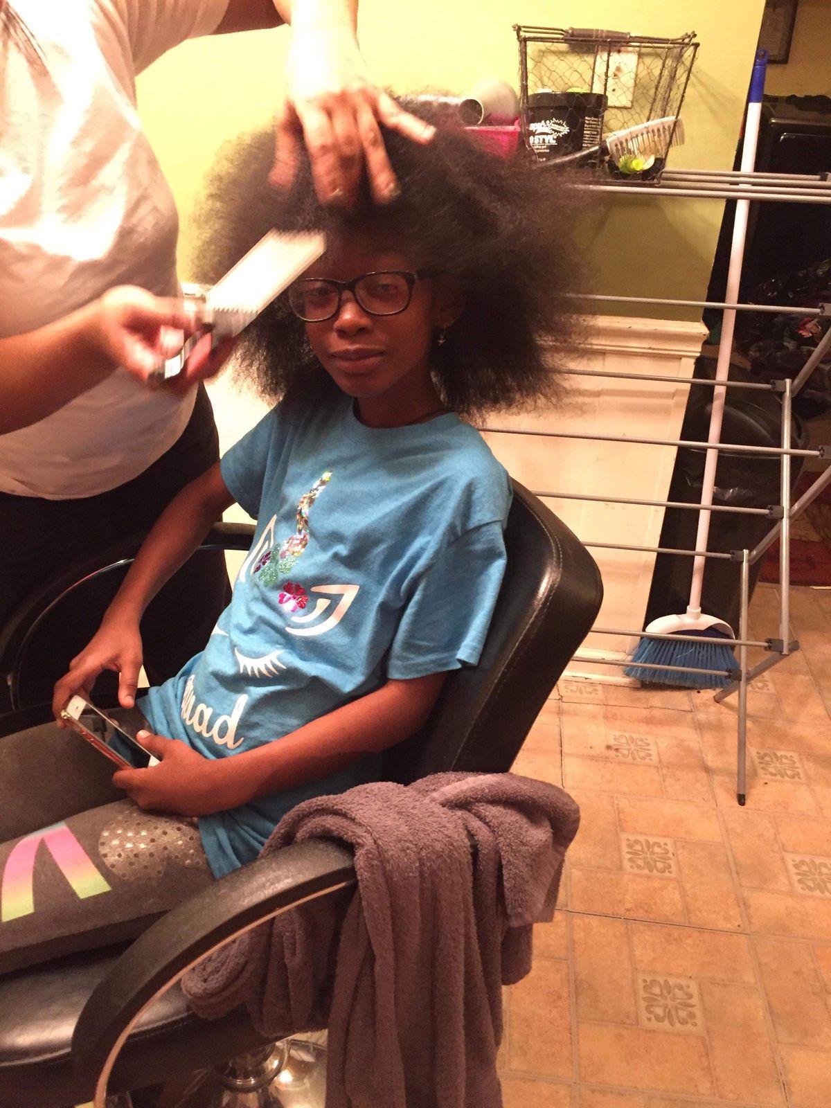 Someone combing a child's hair