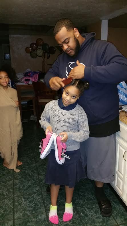 Someone combing a child's hair