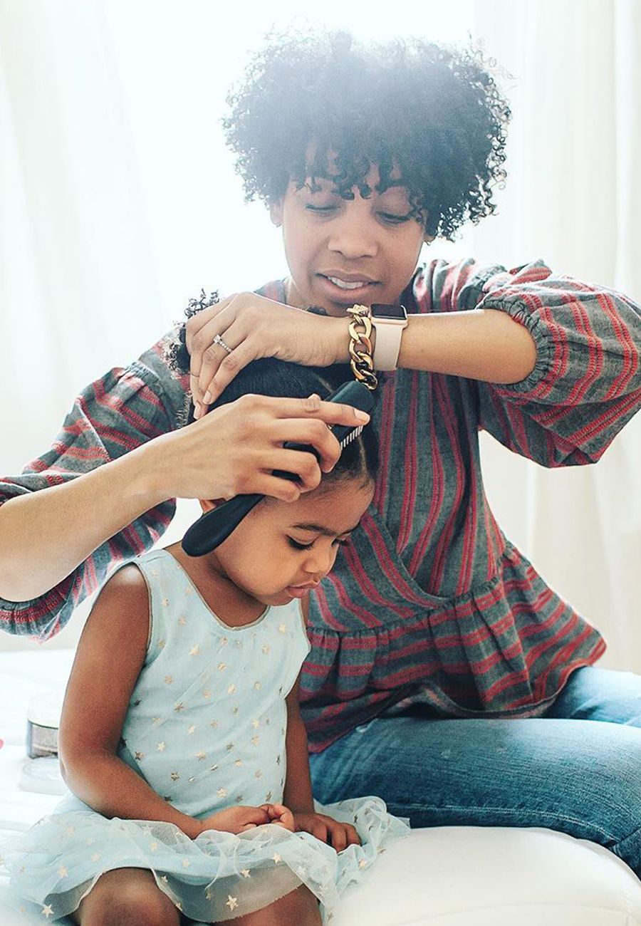 mum brushing her daughter's hair