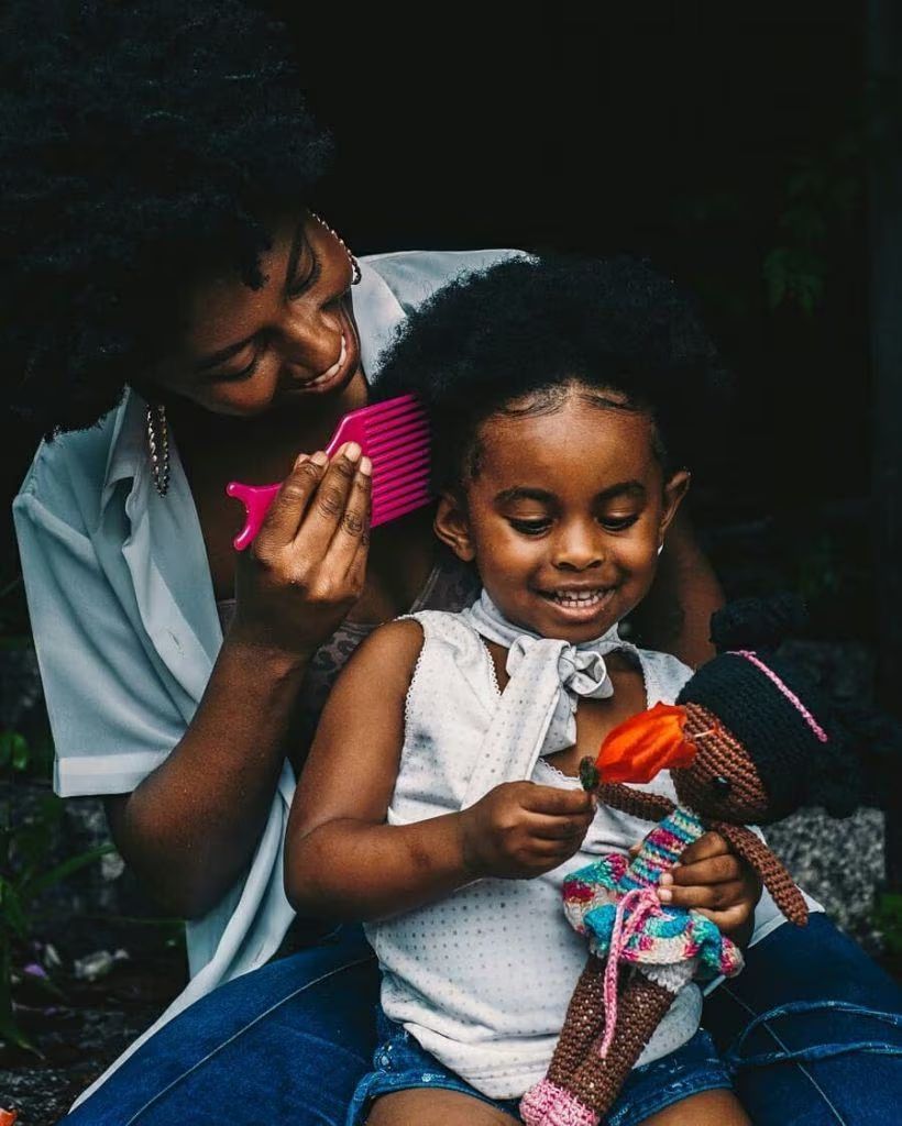 Mother making her child's hair