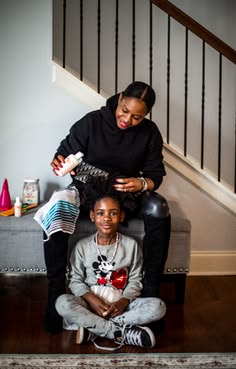 A mother doing her daughter's hair 
