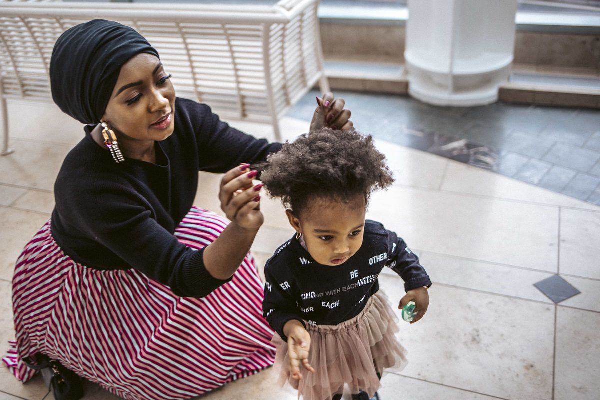 mother trying to brush her child's hair