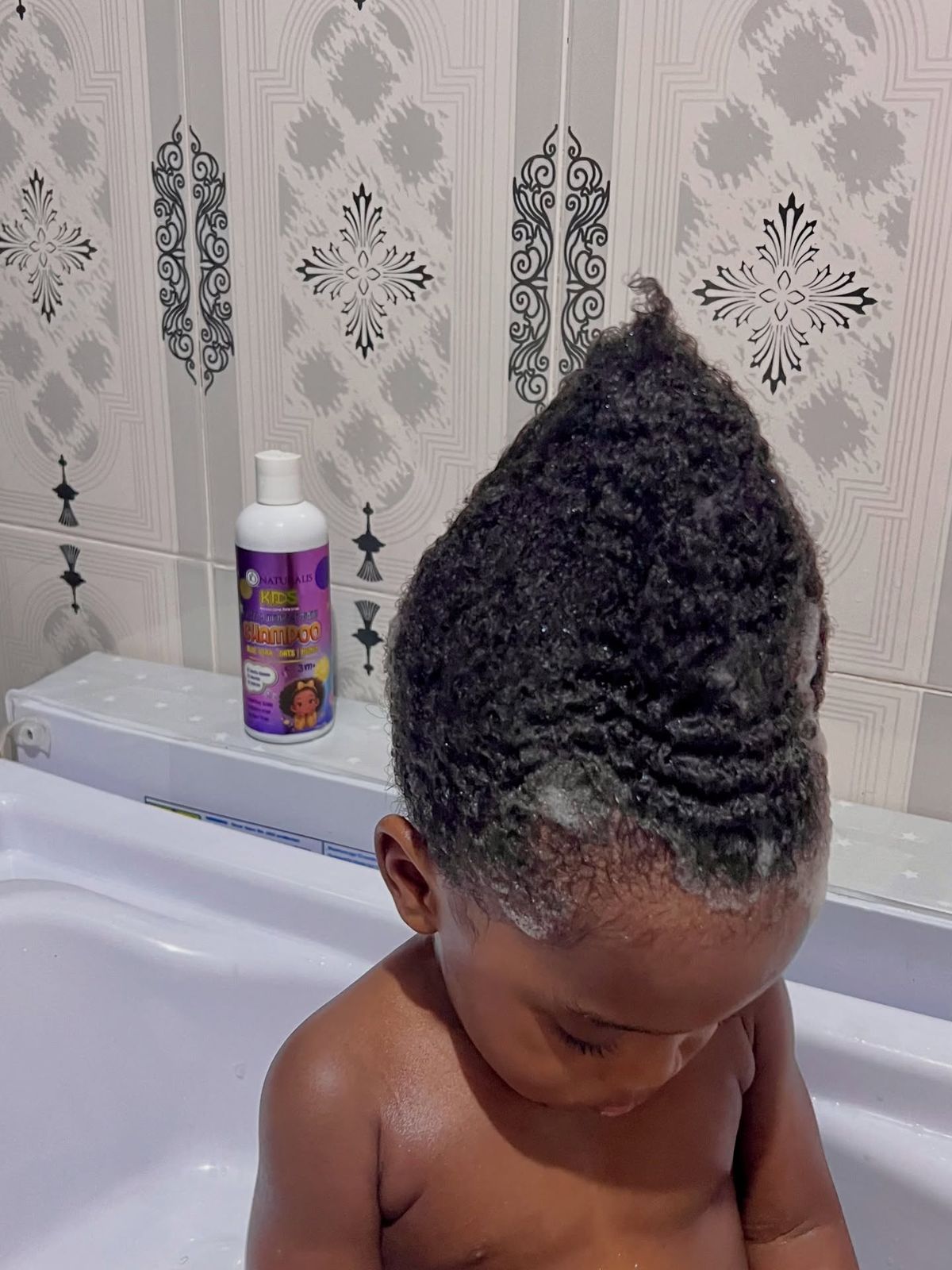 A child with shampoo treatment